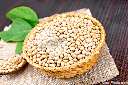 Image of Soybeans in wicker bowl with leaf on board