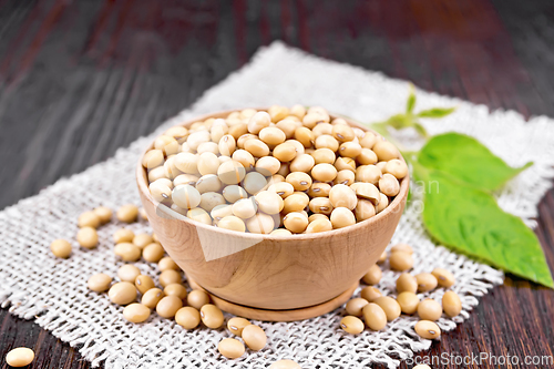 Image of Soybeans in wooden bowl with leaf on dark board