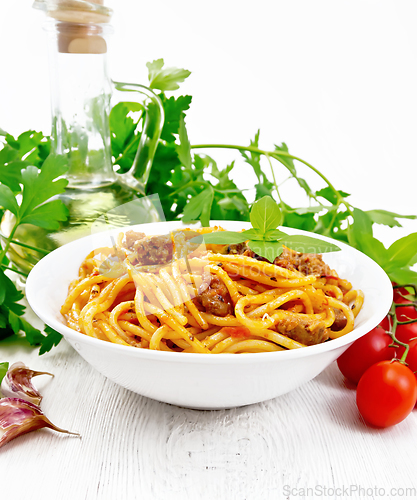 Image of Spaghetti with bolognese in plate on white board