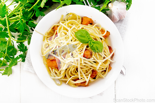 Image of Spaghetti with pumpkin in plate on board top