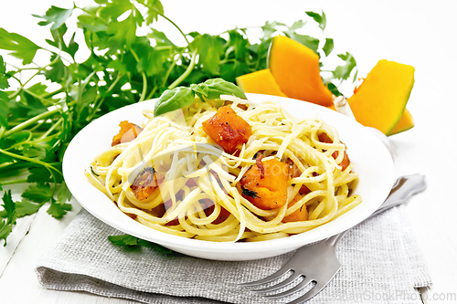 Image of Spaghetti with pumpkin in plate on board