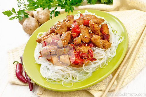 Image of Stir-fry of chicken with peppers in plate on light board