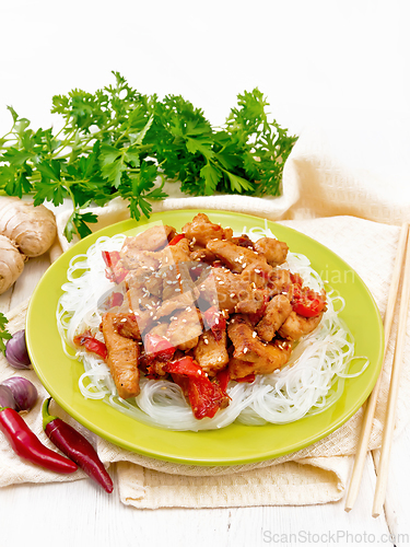 Image of Stir-fry of chicken with peppers in plate on napkin