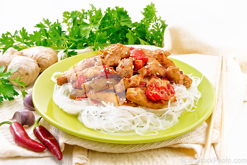 Image of Stir-fry of chicken with peppers in plate on white board