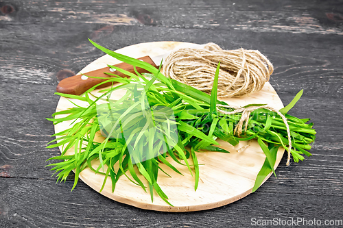 Image of Tarragon with knife on black board