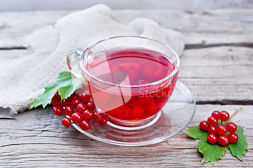 Image of Tea from viburnum in cup with berries on gray board