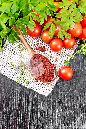 Image of Tomatoes dried in spoon on wooden board top