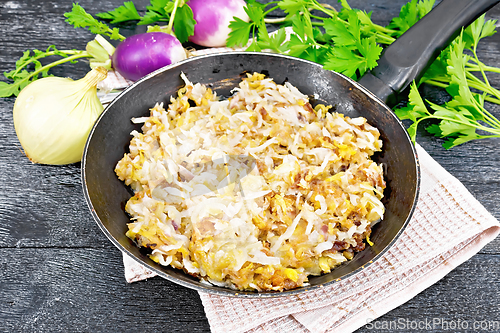 Image of Turnip fried in pan on dark board