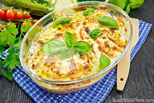 Image of Zucchini baked with tomatoes in pan on board