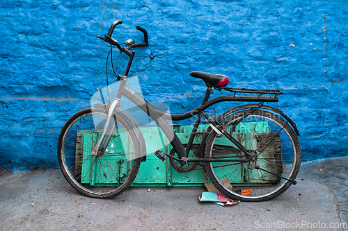 Image of Bicycle by blue house in streets of of Jodhpur