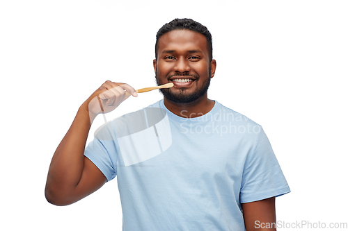 Image of smiling african man with toothbrush cleaning teeth
