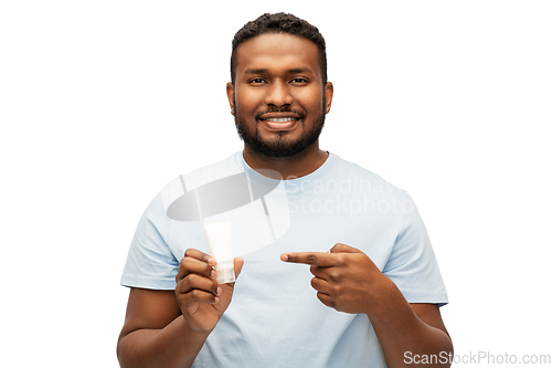 Image of happy african american man showing moisturizer