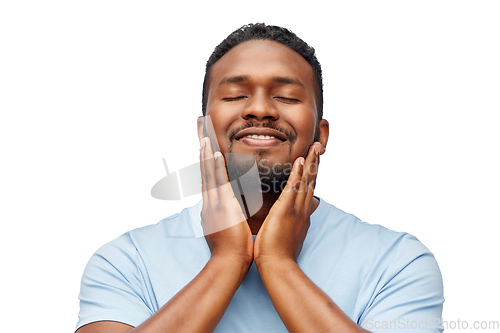 Image of happy african american man touching his beard