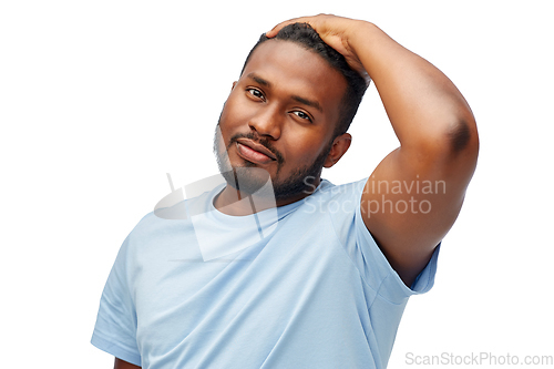 Image of african american man touching his hair