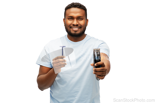 Image of smiling african man with razor blade and trimmer