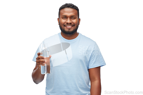 Image of happy african man with water in glass bottle