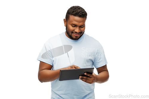 Image of happy african american man with tablet computer