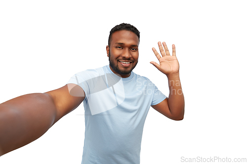 Image of smiling young african american man taking selfie