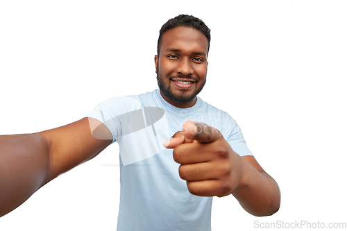 Image of smiling young african american man taking selfie