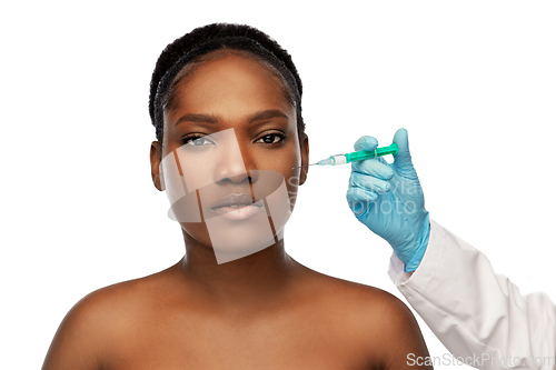 Image of african woman and hand in glove with syringe