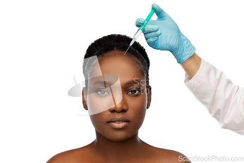 Image of african woman and hand in glove with syringe