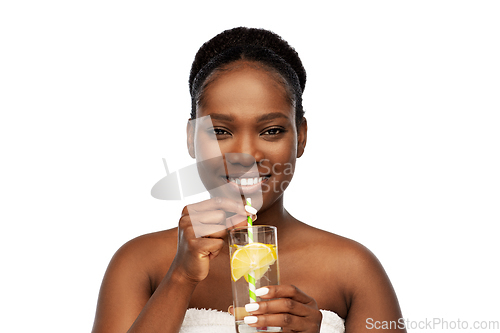 Image of african american woman with glass of fruit water