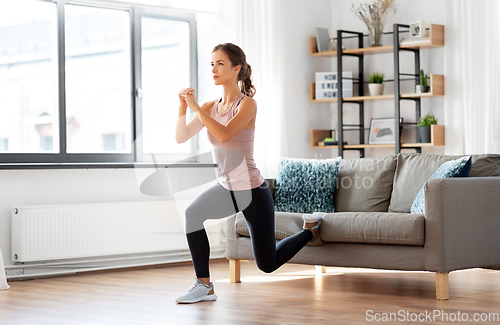 Image of young woman exercising at home