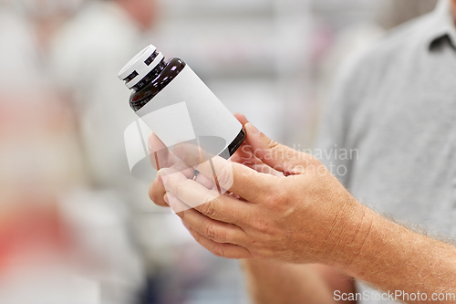 Image of close up of customer choosing medicine at pharmacy