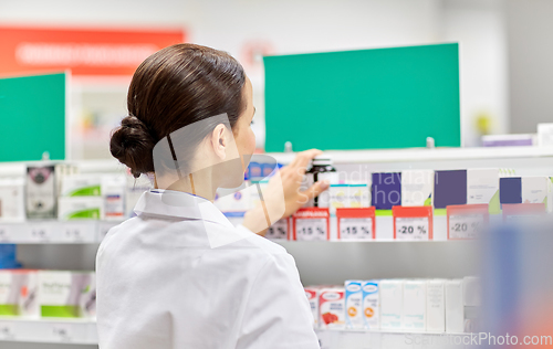 Image of female pharmacist with medicine at pharmacy