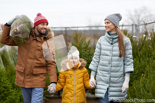 Image of happy family buying christmas tree at market