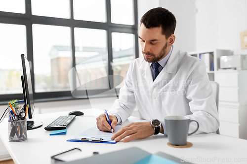 Image of male doctor with clipboard at hospital