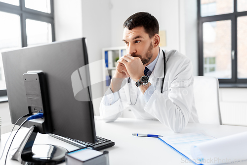 Image of male doctor with computer working at hospital