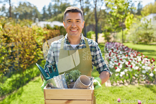 Image of happy man with tools in box at summer garden