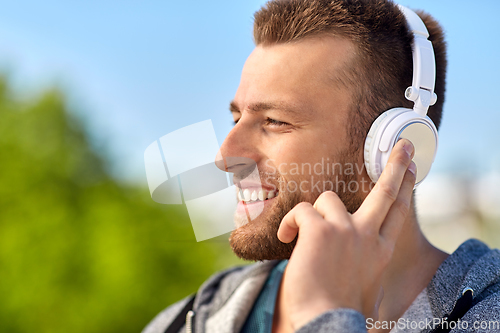 Image of man in headphones listening to music outdoors