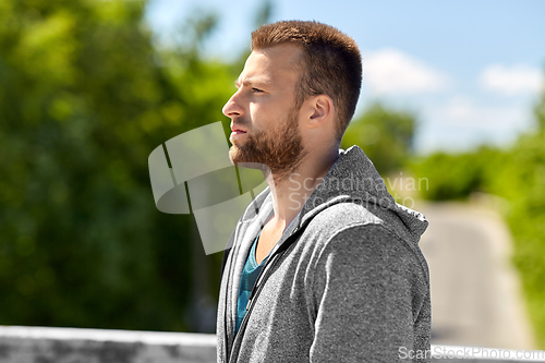 Image of portrait of young man outdoors