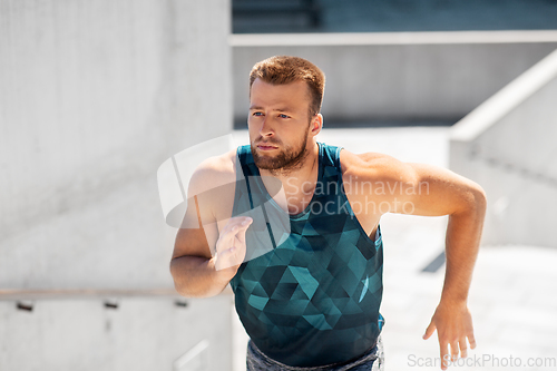 Image of young man running upstairs