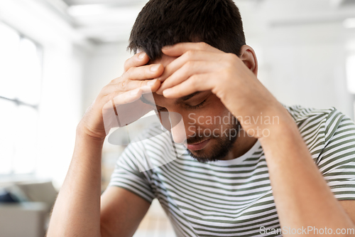 Image of close up of stressed man having headache at home