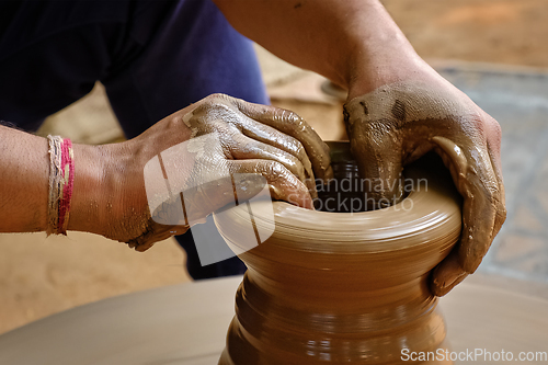 Image of Indian potter hands at work, Shilpagram, Udaipur, Rajasthan, India