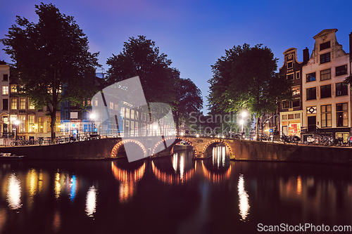 Image of Amterdam canal, bridge and medieval houses in the evening