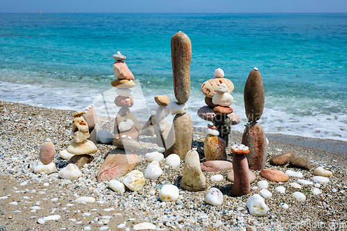 Image of Concept of balance and harmony - pebble stone stacks on the beach