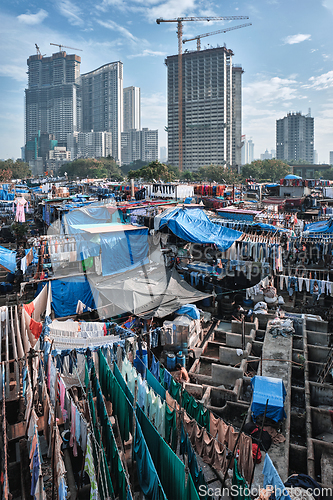 Image of Dhobi Ghat is an open air laundromat lavoir in Mumbai, India with laundry drying on ropes