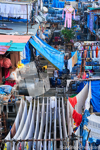 Image of Dhobi Ghat is an open air laundromat lavoir in Mumbai, India with laundry drying on ropes