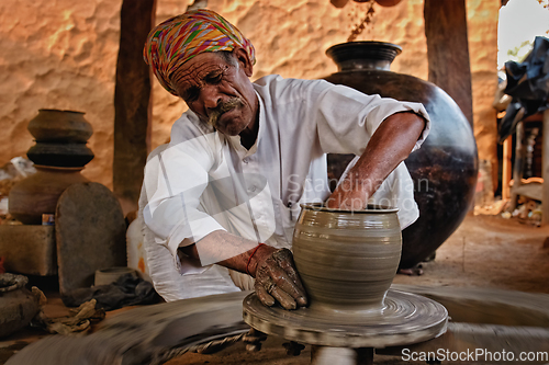 Image of Indian potter at work. Handwork craft from Shilpagram, Udaipur, Rajasthan, India