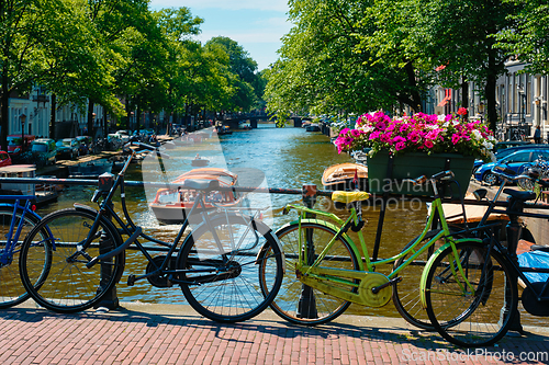 Image of Amsterdam canal with boats and bicycles on a bridge