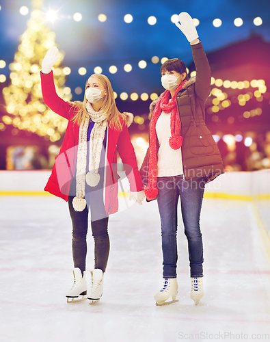 Image of women in masks at christmas skating rink