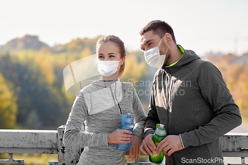Image of couple in mask with bottles of water training