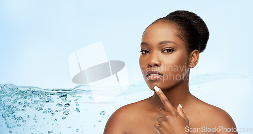 Image of portrait of african woman touching her face