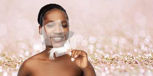 Image of happy african american woman with feather