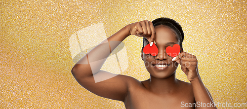 Image of smiling african american woman with red hearts