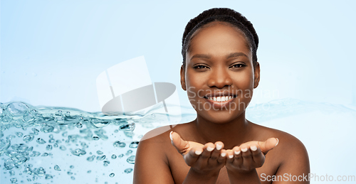 Image of happy african american woman holding something